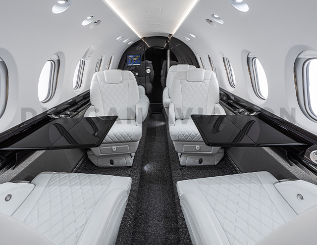 Black lacquer conference tables with white leather club seats in updated Hawker 800