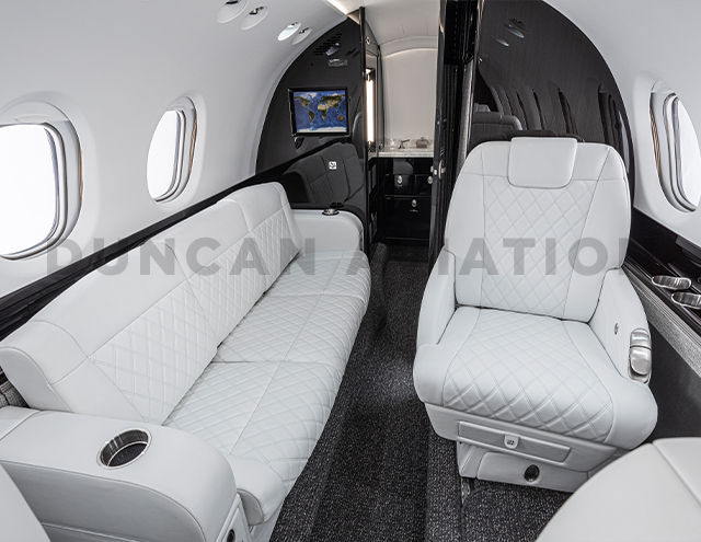 White leather club seat and divan with custom diamond stitching in Hawker 800