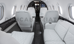 White leather club seats and divan in refurbished Hawker 800