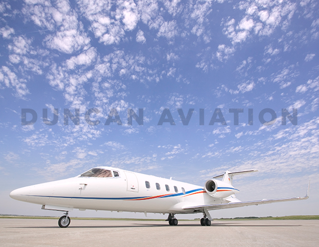 Sleek Learjet 60 exterior with new white paint and blue and red accent stripes